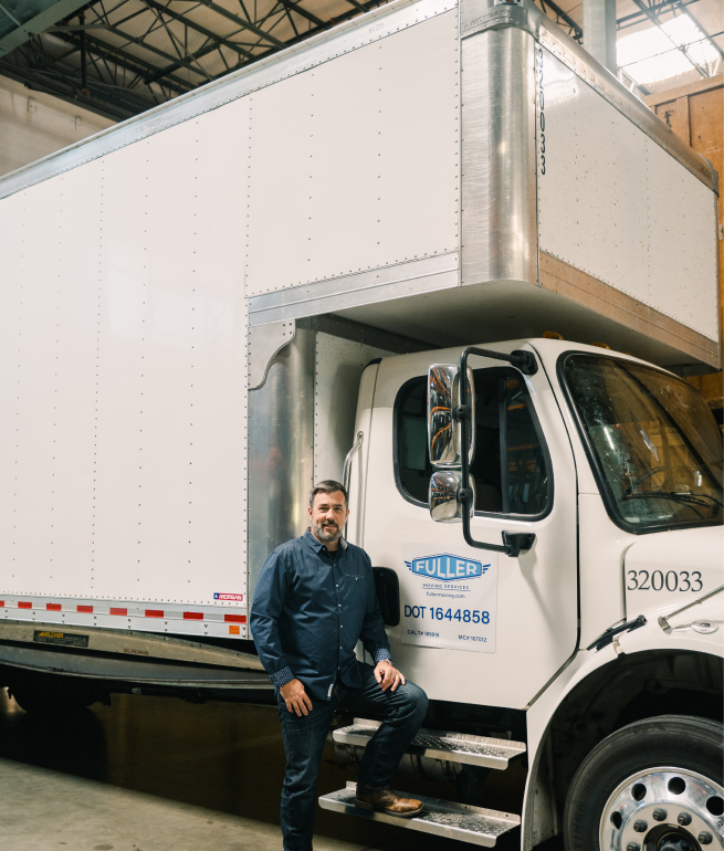 fuller owner Nathan Fuller posing with a moving truck